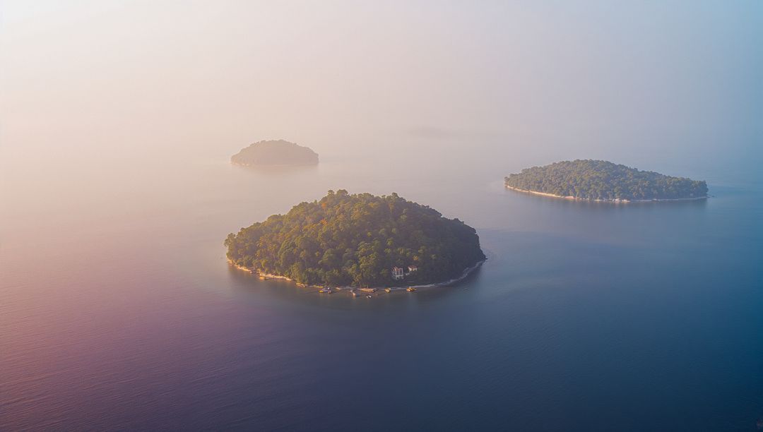 Mystical Islands Enveloped by Mist at Sunrise