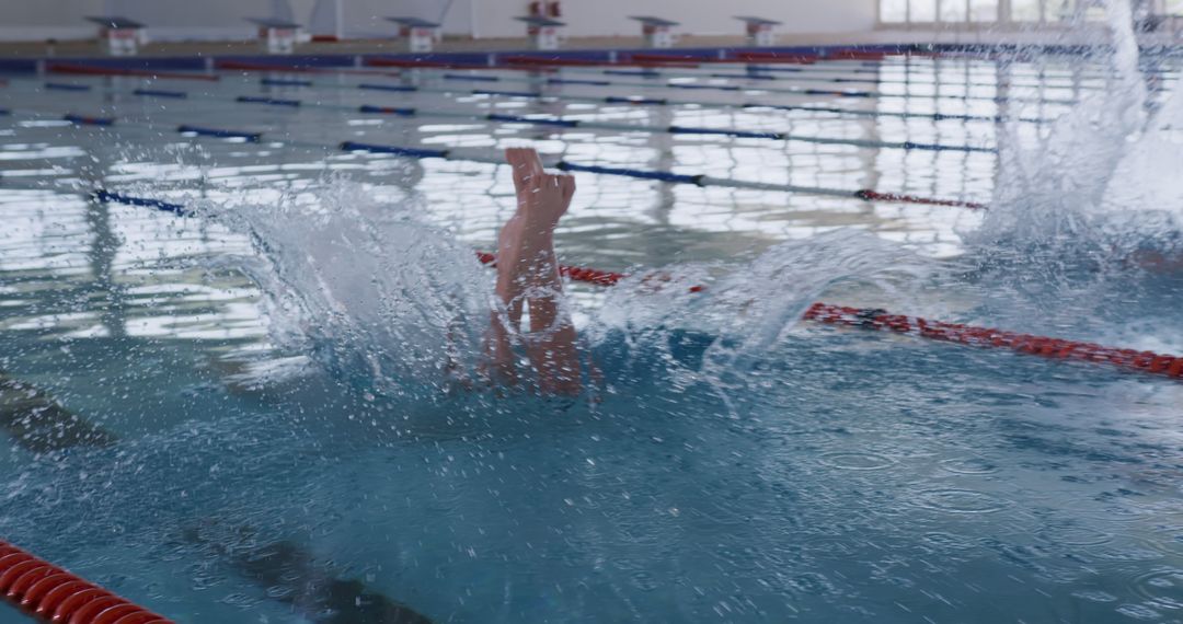 Swimmer Diving into Indoor Pool with Big Splash - Free Images, Stock Photos and Pictures on Pikwizard.com