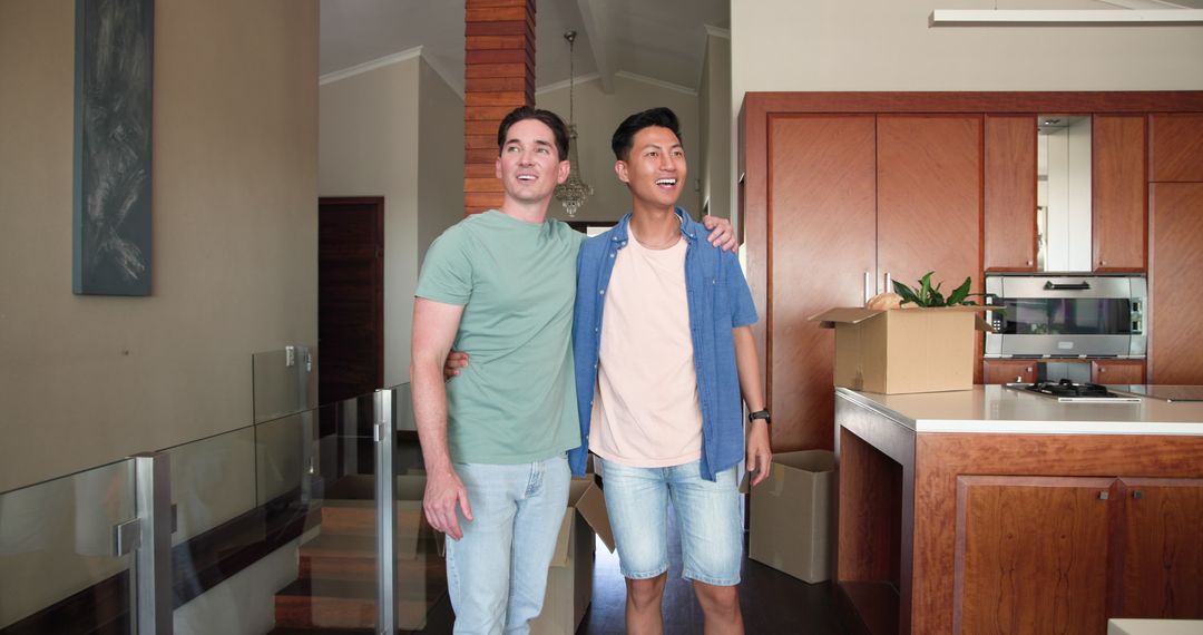 Smiling Male Couple Standing in Their New Home with Moving Boxes