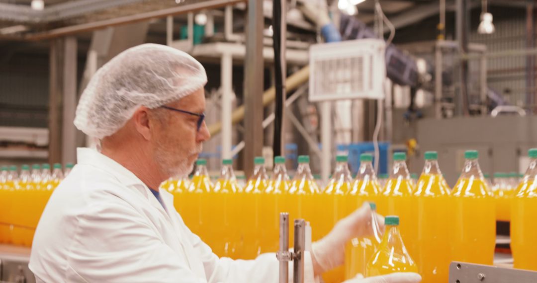 Factory Worker Checking Bottles on Juice Production Line - Free Images, Stock Photos and Pictures on Pikwizard.com