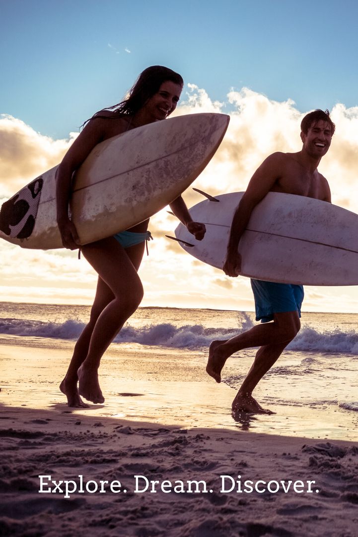 Couple with Surfboards Jogging on Sunset Beach Adventure