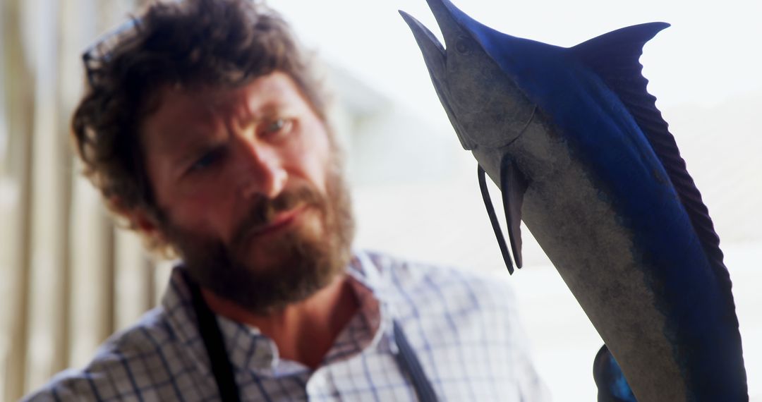 Bearded Man Closely Examining Detailed Trophy Fish On Display - Free Images, Stock Photos and Pictures on Pikwizard.com