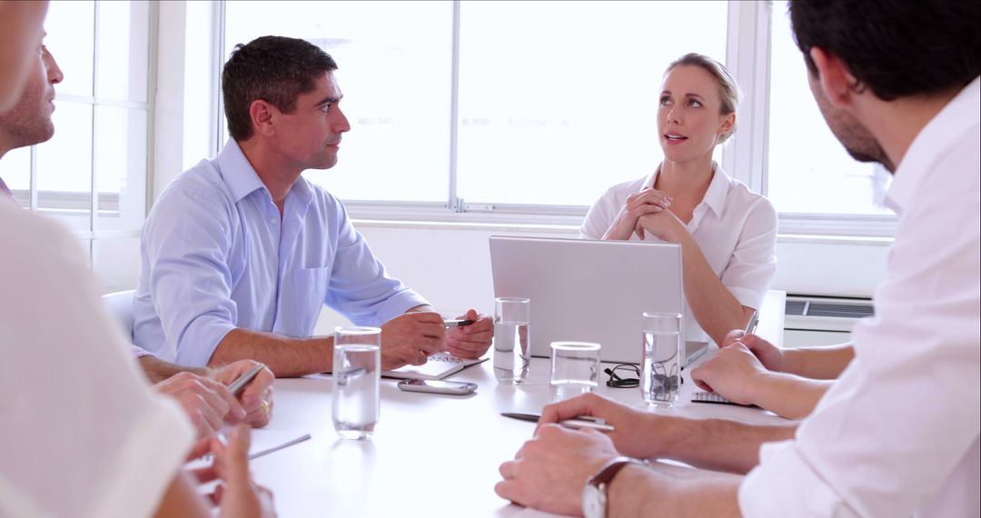 Colleagues Discussing At Business Meeting In Modern Office - Free Images, Stock Photos and Pictures on Pikwizard.com