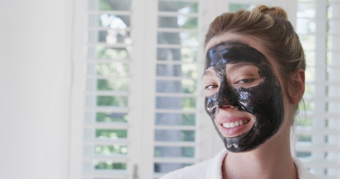 Smiling Woman with Charcoal Facial Mask at Home - Free Images, Stock Photos and Pictures on Pikwizard.com