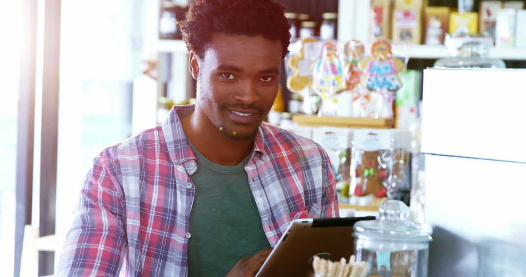 Casual Man with Tablet in Vibrant Cafeteria