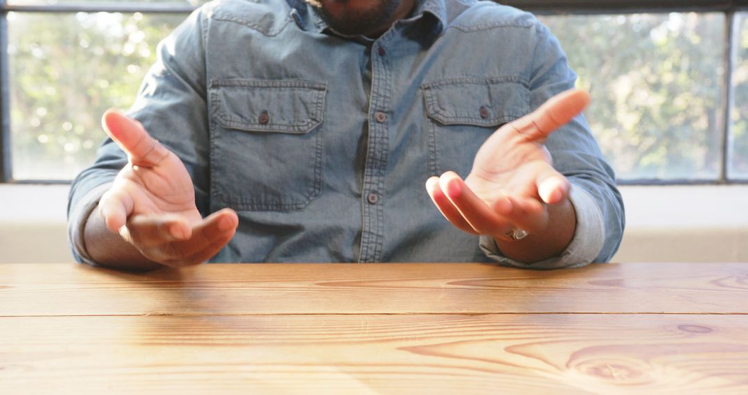 Confident Businessman Gesturing During Team Meeting in Office