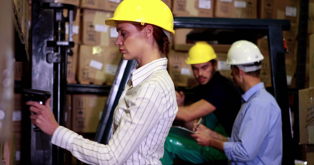 Warehouse Workers Handling Inventory while Operating Machinery - Free Images, Stock Photos and Pictures on Pikwizard.com