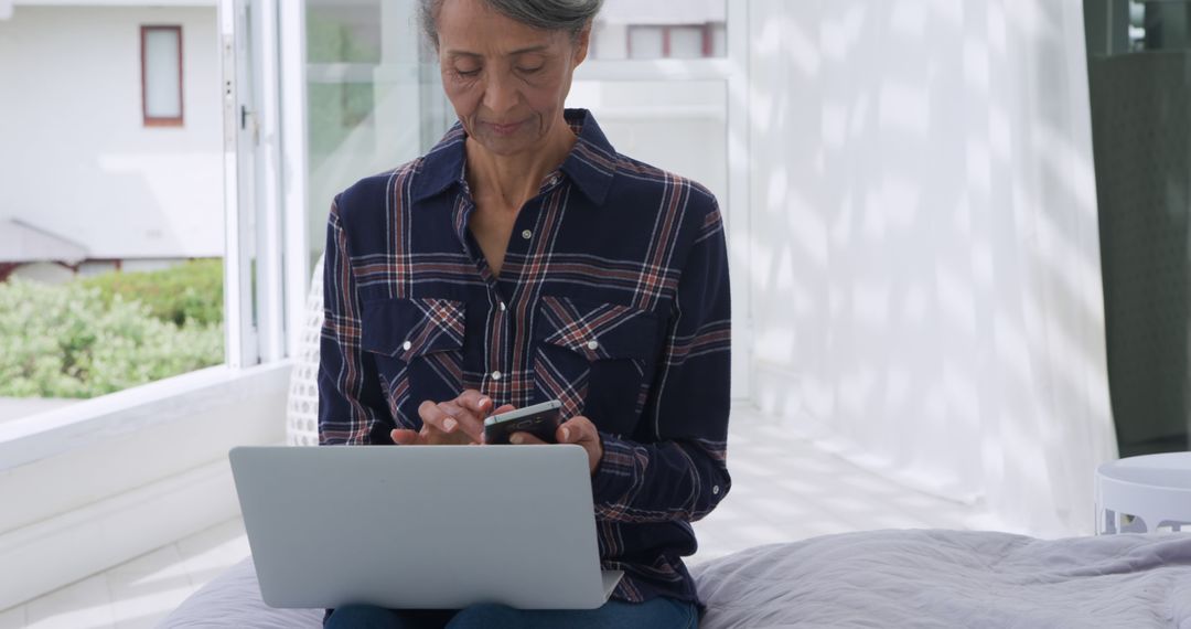 Senior Woman Using Smartphone and Laptop Dialing Health Services - Free Images, Stock Photos and Pictures on Pikwizard.com