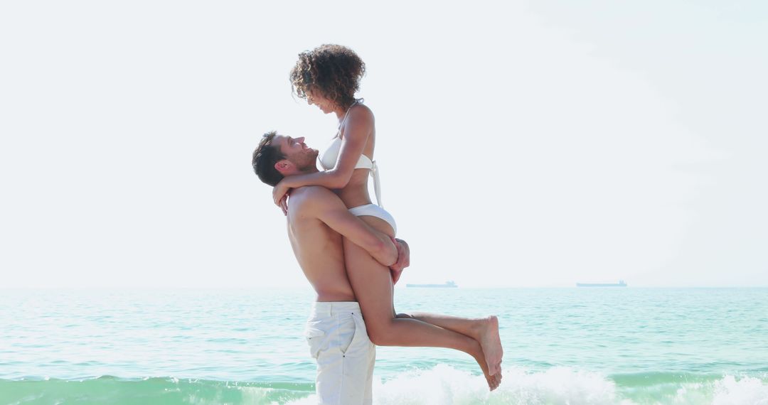 Couple in Love Enjoying Beach Day, Man Lifting Woman in Joy - Free Images, Stock Photos and Pictures on Pikwizard.com