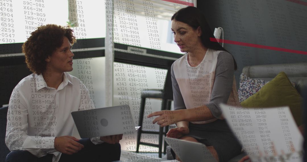 Diverse Business Team Analyzing Data on Laptops