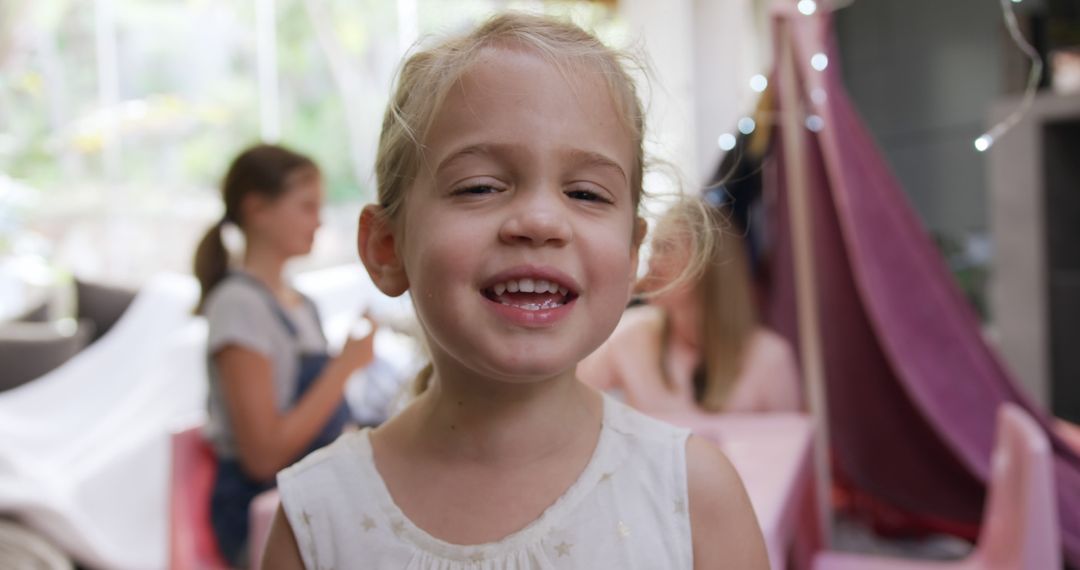 Smiling Young Girl with Friends in Playroom - Free Images, Stock Photos and Pictures on Pikwizard.com