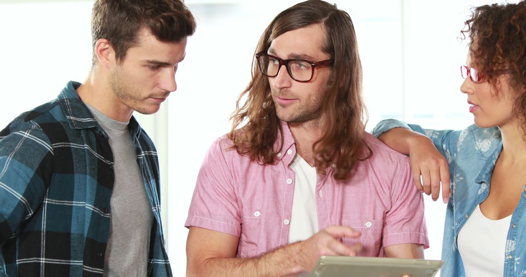 Diverse Team Collaborating on Digital Project in Casual Work Environment