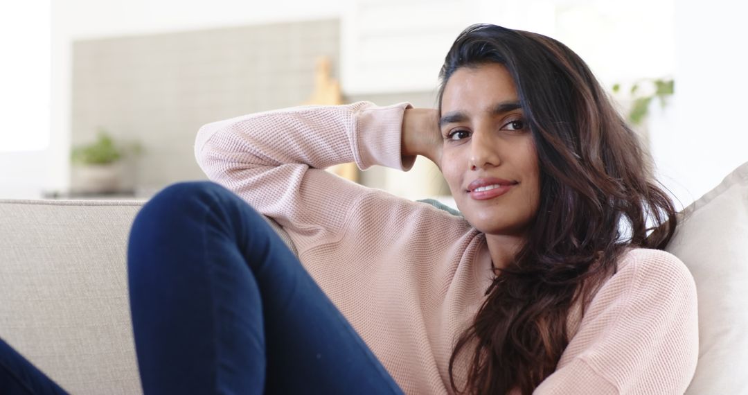 Smiling Woman Relaxing on Couch Enjoying Leisure Time