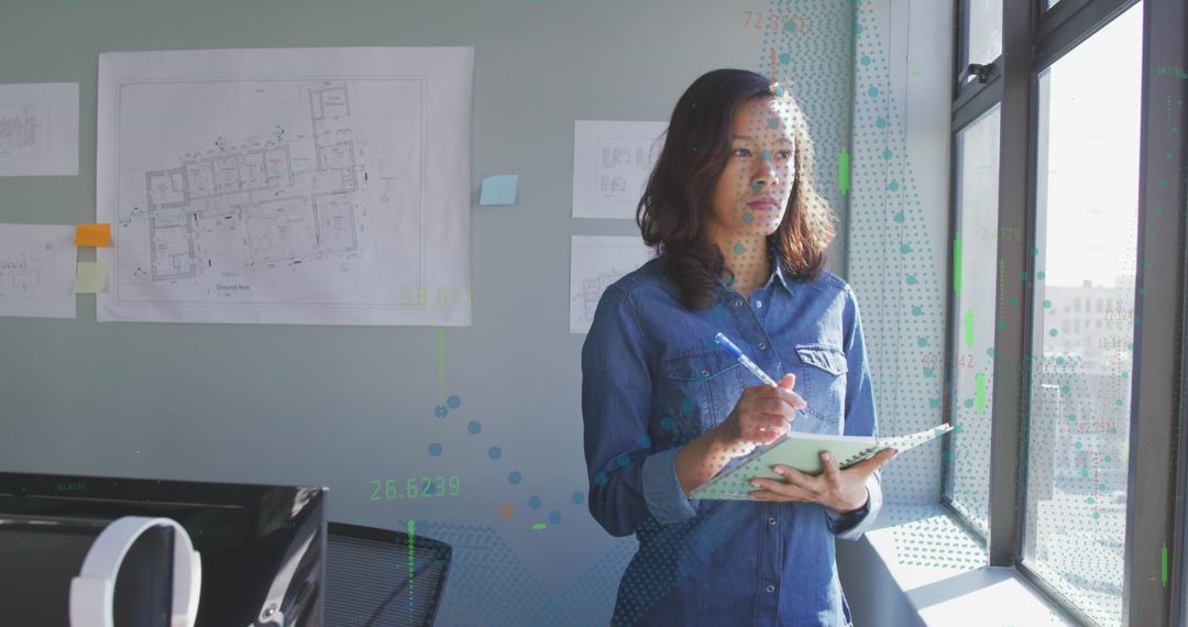 Creative Designer Using Tablet with Stylus in Modern Workspace