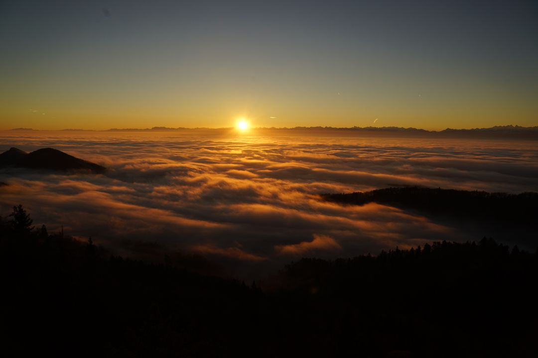 Breathtaking Sunset Over Mountain Covered in Clouds - Free Images, Stock Photos and Pictures on Pikwizard.com