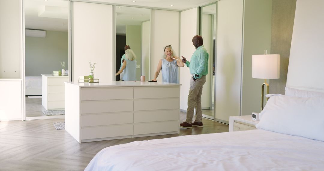Senior Real Estate Agent Assisting Client in Elegant Bedroom Space