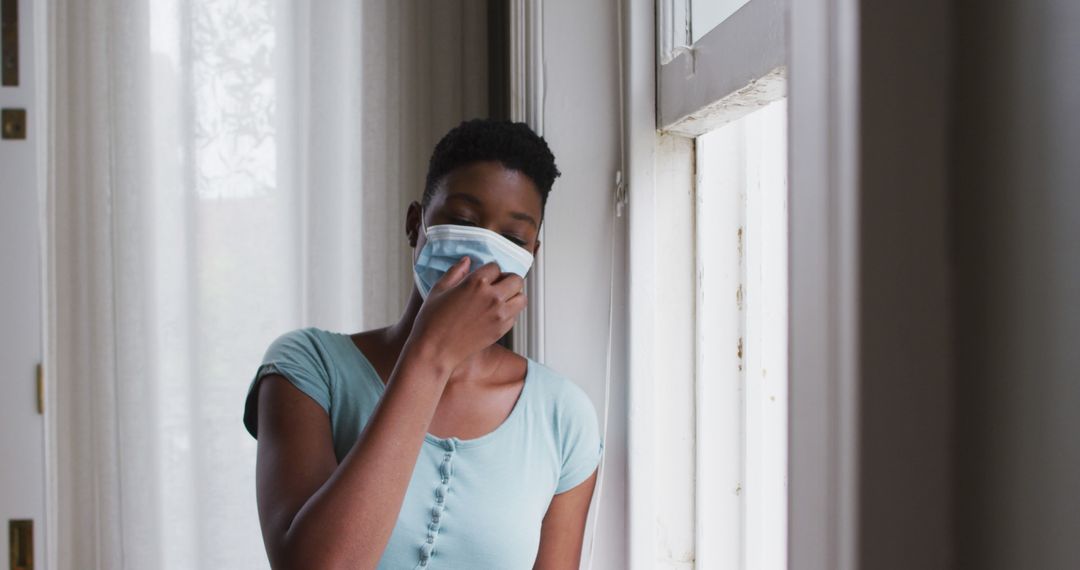 Woman Removing Face Mask and Looking Out of Window - Free Images, Stock Photos and Pictures on Pikwizard.com