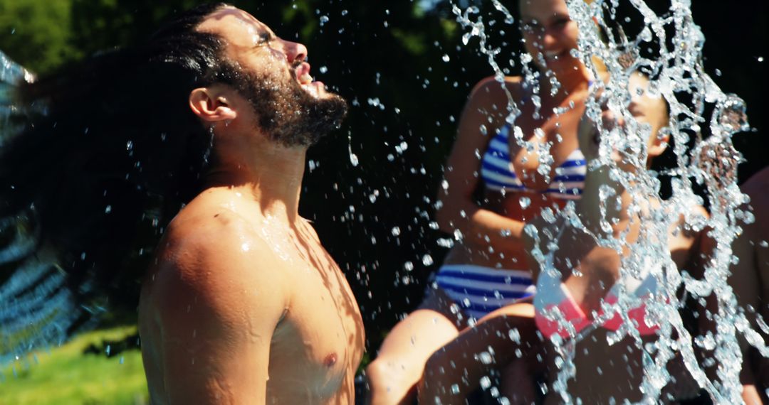 Man Enjoying Refreshing Water Splash in Summer - Free Images, Stock Photos and Pictures on Pikwizard.com