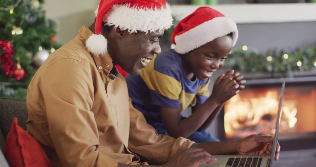 African American Father and Son Using Laptop During Christmas - Free Images, Stock Photos and Pictures on Pikwizard.com