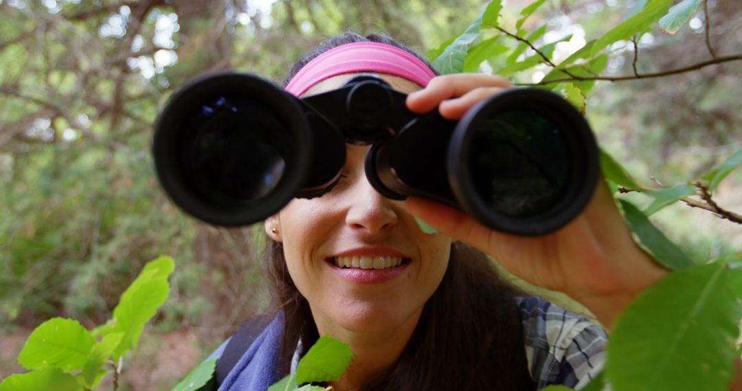 Woman Using Binoculars for Bird Watching in Forest - Free Images, Stock Photos and Pictures on Pikwizard.com