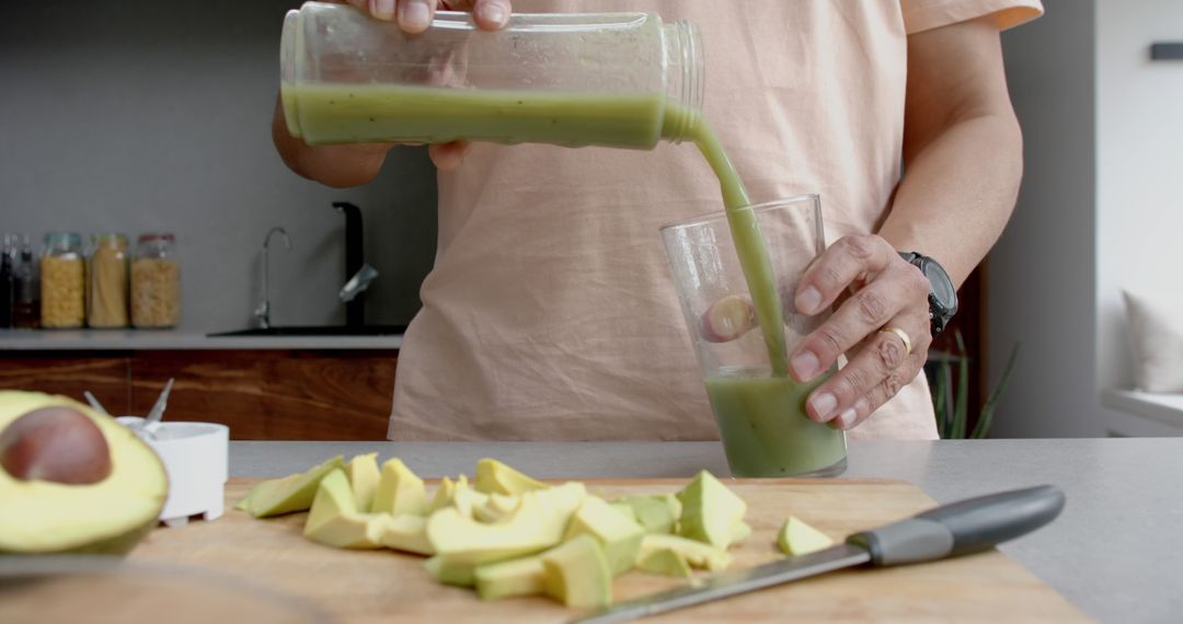 Person Pouring Healthy Green Smoothie in Kitchen - Free Images, Stock Photos and Pictures on Pikwizard.com