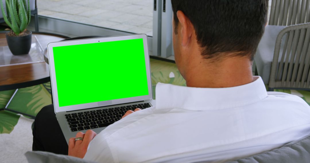 Businessman Working Remotely on Laptop with Green Screen - Free Images, Stock Photos and Pictures on Pikwizard.com