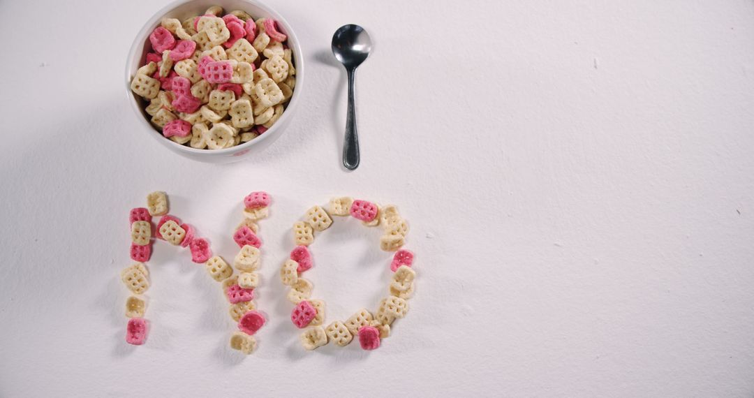 Cereal Bowl with Spoon and LAID OUT Crunchy O's Forming the Word 'NO' on White Background - Free Images, Stock Photos and Pictures on Pikwizard.com