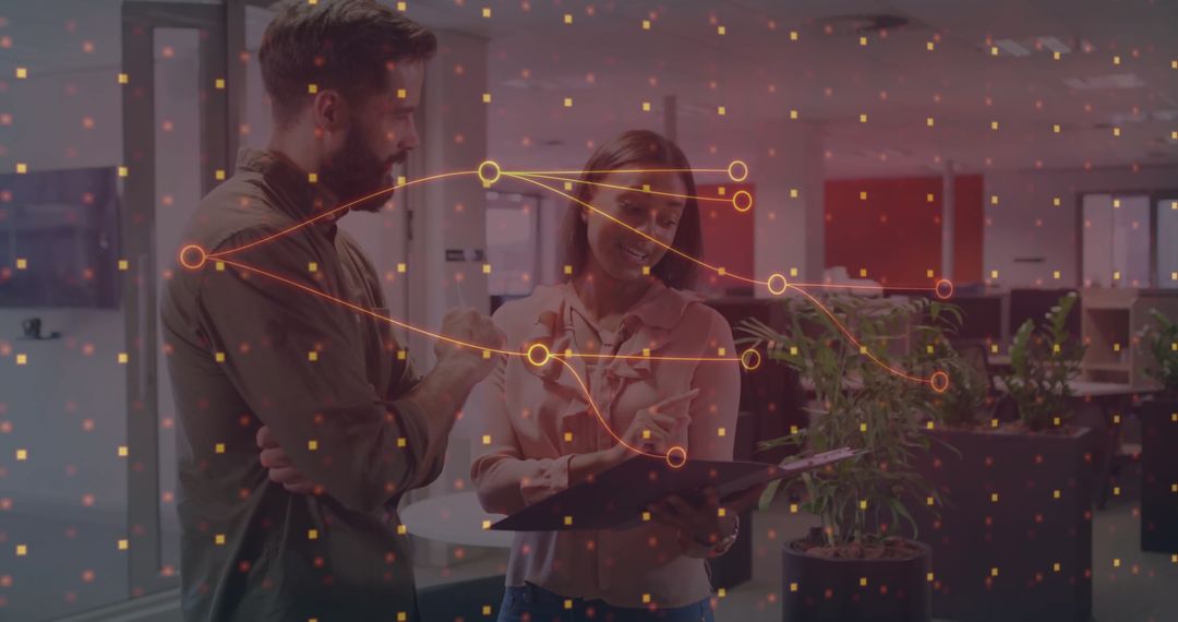 Colleagues Collaborating on Digital Project with Data Overlay