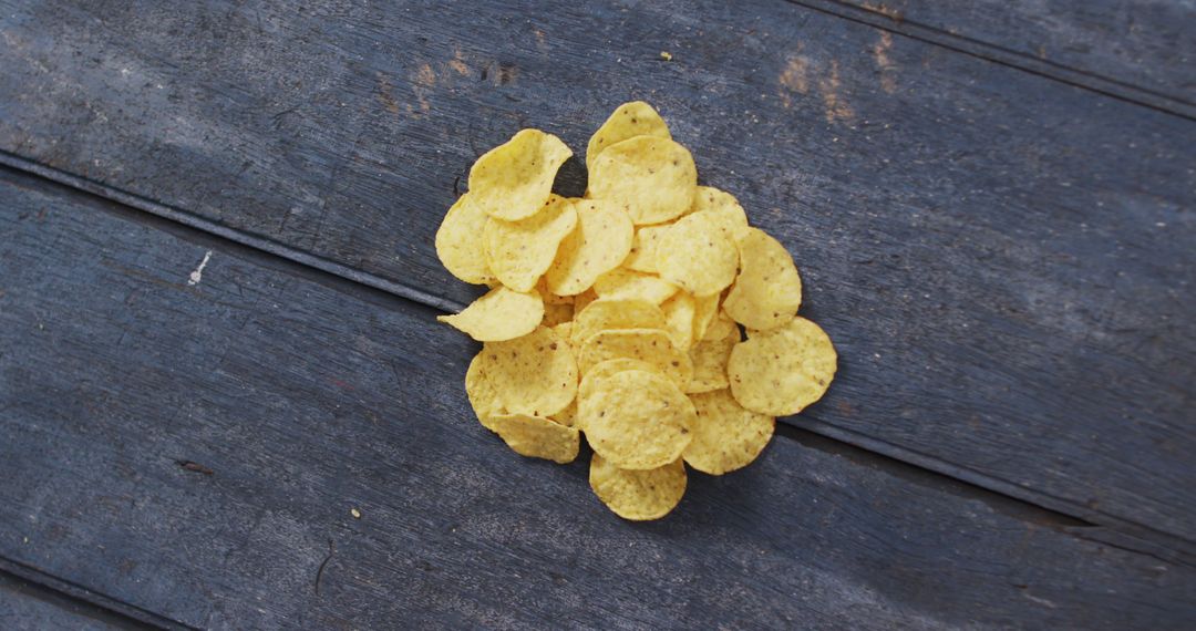 Close up view of potato chips falling with copy space on wooden surface - Free Images, Stock Photos and Pictures on Pikwizard.com