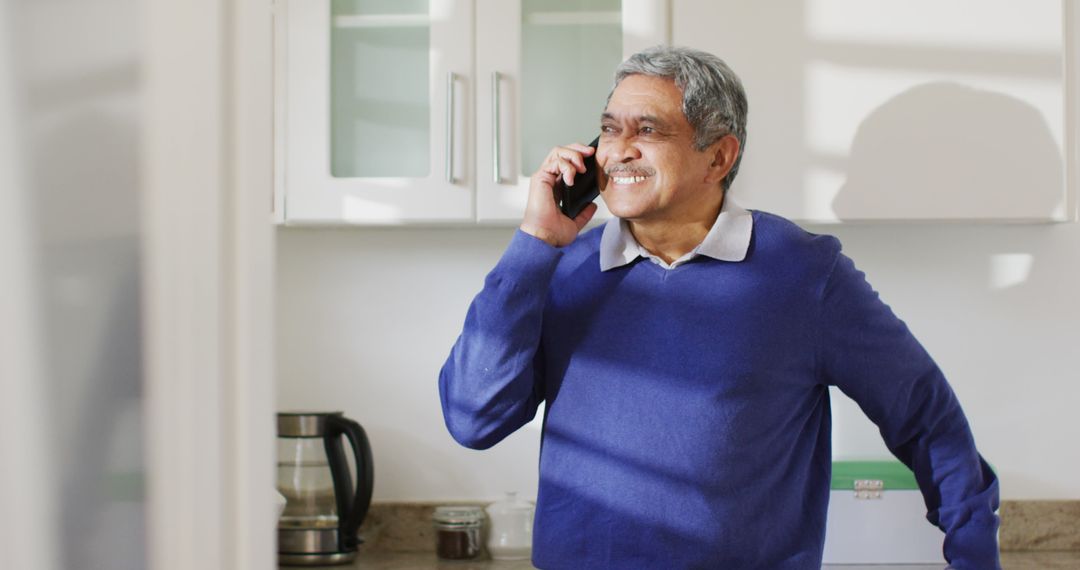 Smiling Elderly Man Making Phone Call in Modern Kitchen - Free Images, Stock Photos and Pictures on Pikwizard.com