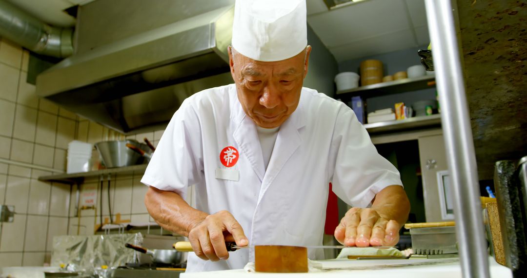 Experienced Japanese Chef Preparing Traditional Cuisine in Kitchen - Free Images, Stock Photos and Pictures on Pikwizard.com