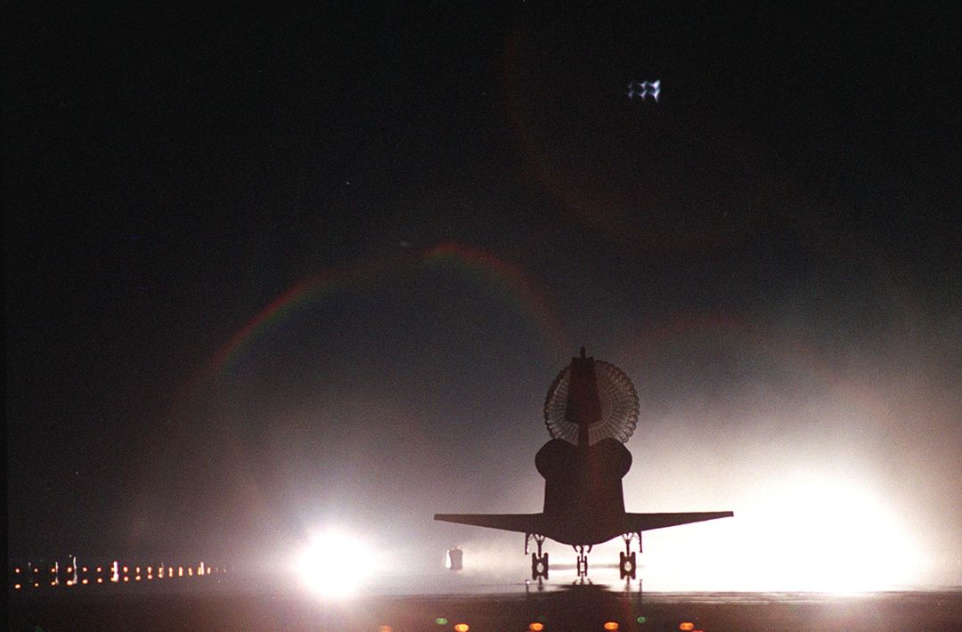 Space Shuttle Atlantis Night Landing with Drag Chute Deployed - Free Images, Stock Photos and Pictures on Pikwizard.com