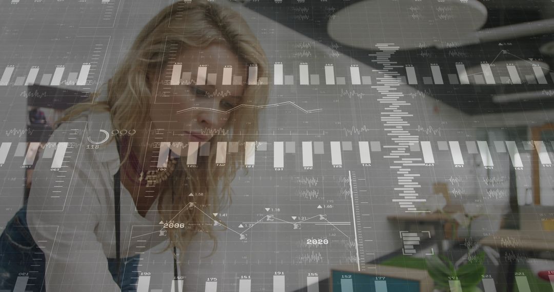 Data Analyst Reviewing Charts in Modern Office Environment