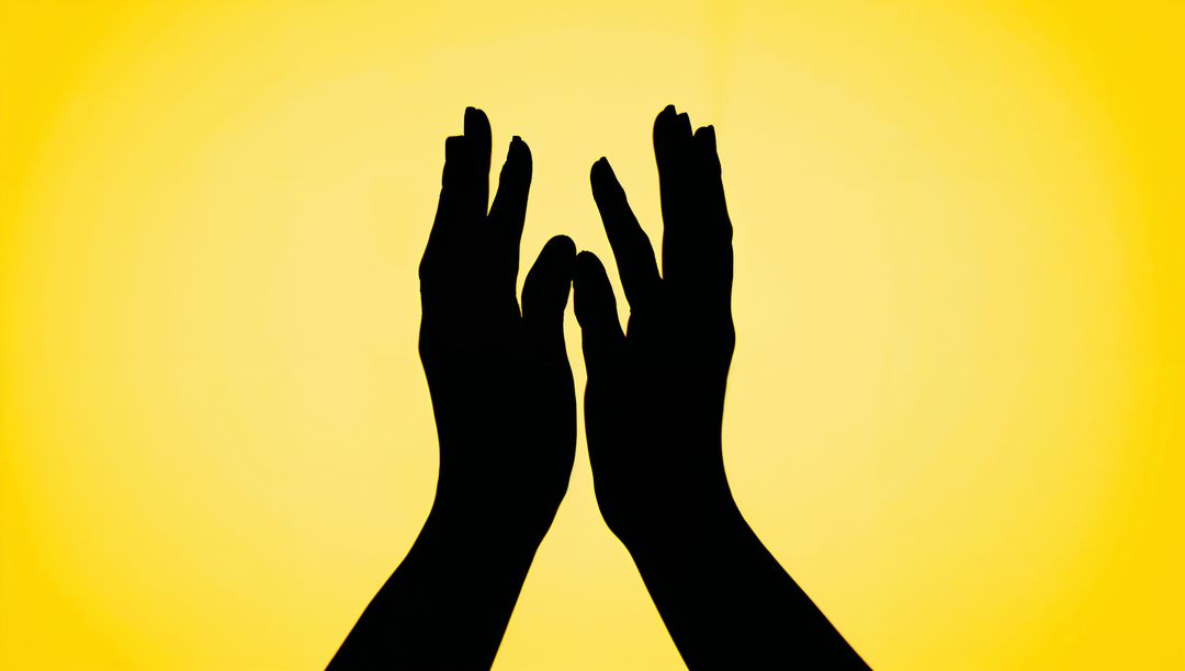 Reaching Hands Silhouette on Bright Yellow Gradient Evoking Connection and Hope