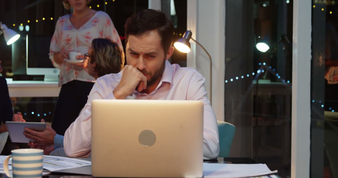 Stressed Businessman Working Late at Office with Laptop - Free Images, Stock Photos and Pictures on Pikwizard.com