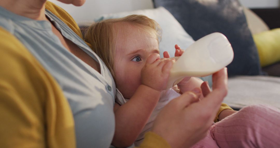 Mother Feeding Baby with Milk Bottle at Home - Free Images, Stock Photos and Pictures on Pikwizard.com