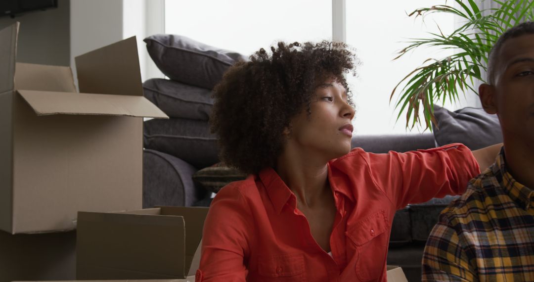 Young Couple Relaxing Together After a Move with Cardboard Boxes