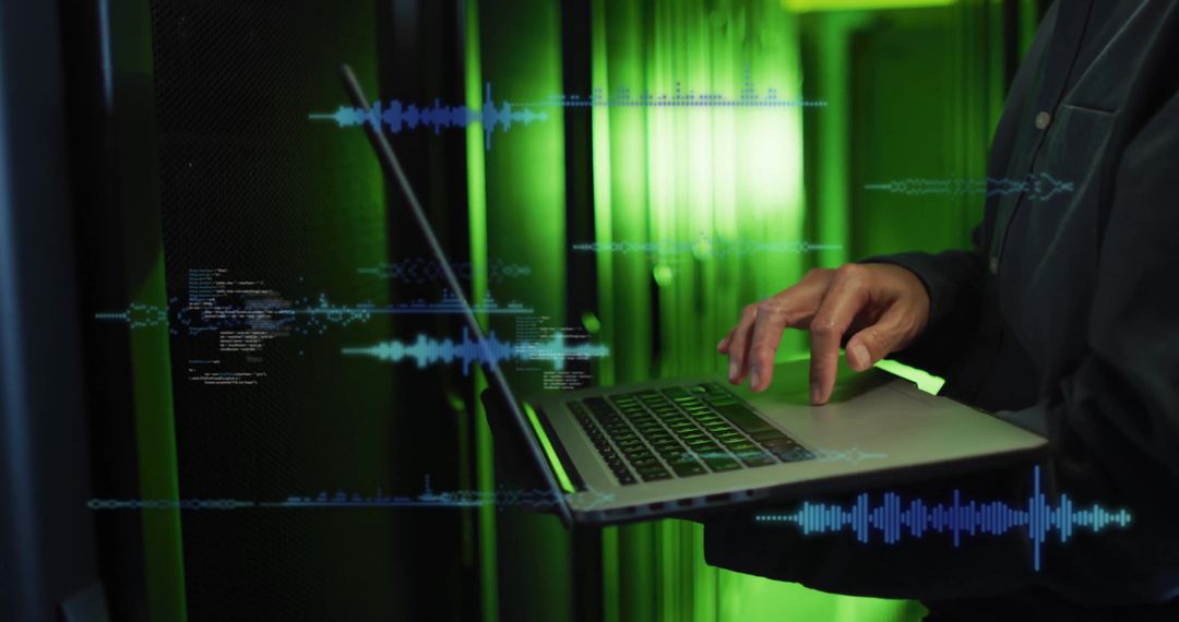 Person Typing on Laptop with Sound Waveforms in Green Ambient Light