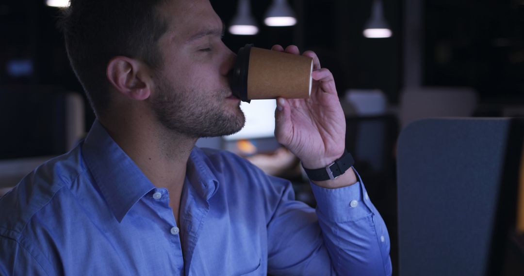 Office Worker Drinking Coffee at Night - Free Images, Stock Photos and Pictures on Pikwizard.com