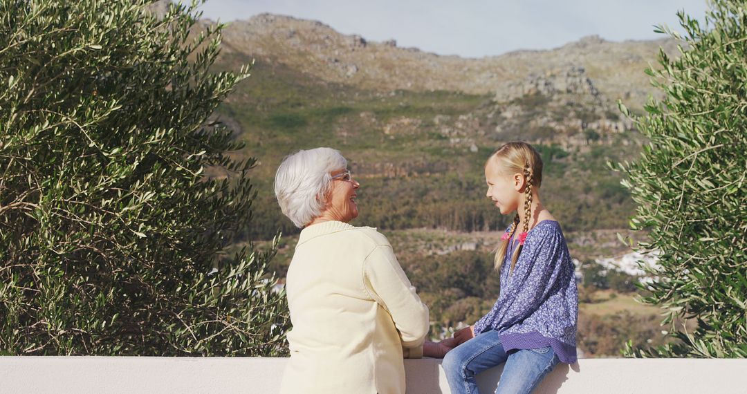 Grandmother and Granddaughter Enjoying Outdoor View - Free Images, Stock Photos and Pictures on Pikwizard.com