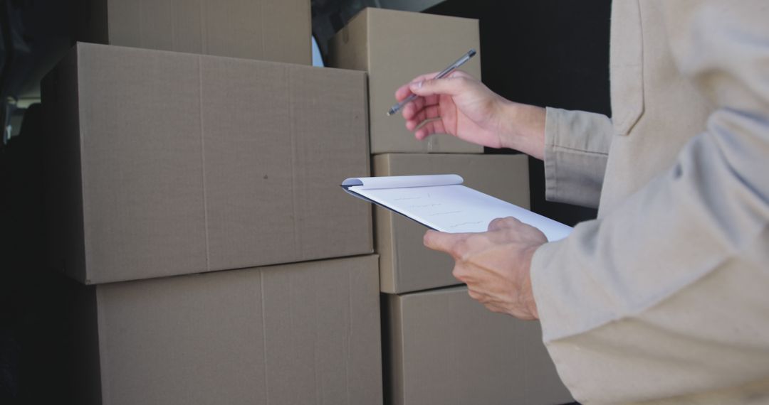 Warehouse Worker Organizing Stacked Boxes for Inventory - Free Images, Stock Photos and Pictures on Pikwizard.com