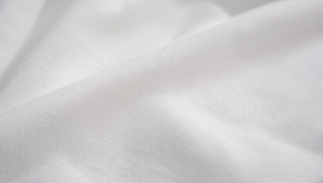 White Woven Fabric Macro Texture with Soft Folds and Subtle Light Highlights