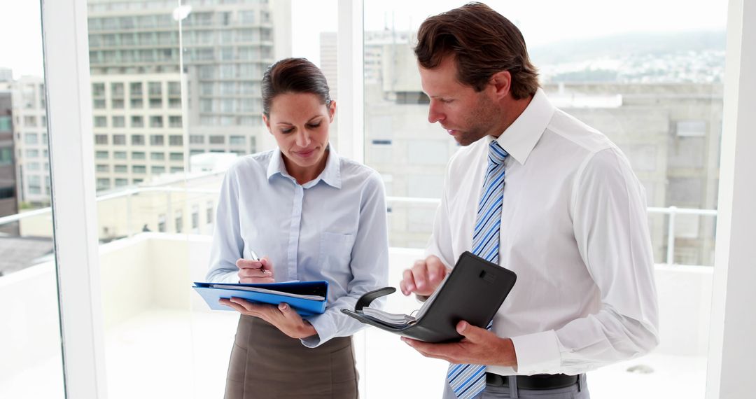 Business Team Planning Schedules in Office Setting