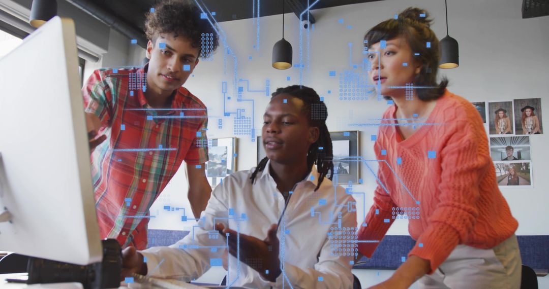 Collaborating team analyzing holographic data on desktop monitor in creative tech office