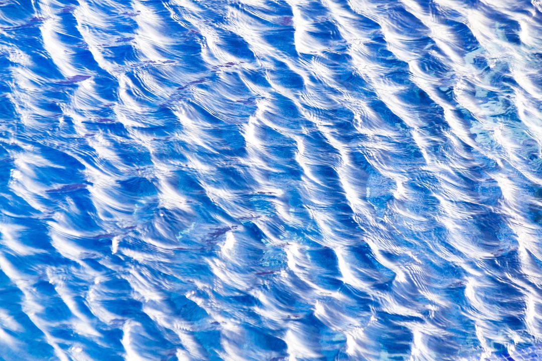 Close-Up Textured Blue Water Surface with Gentle Ripples - Free Images, Stock Photos and Pictures on Pikwizard.com