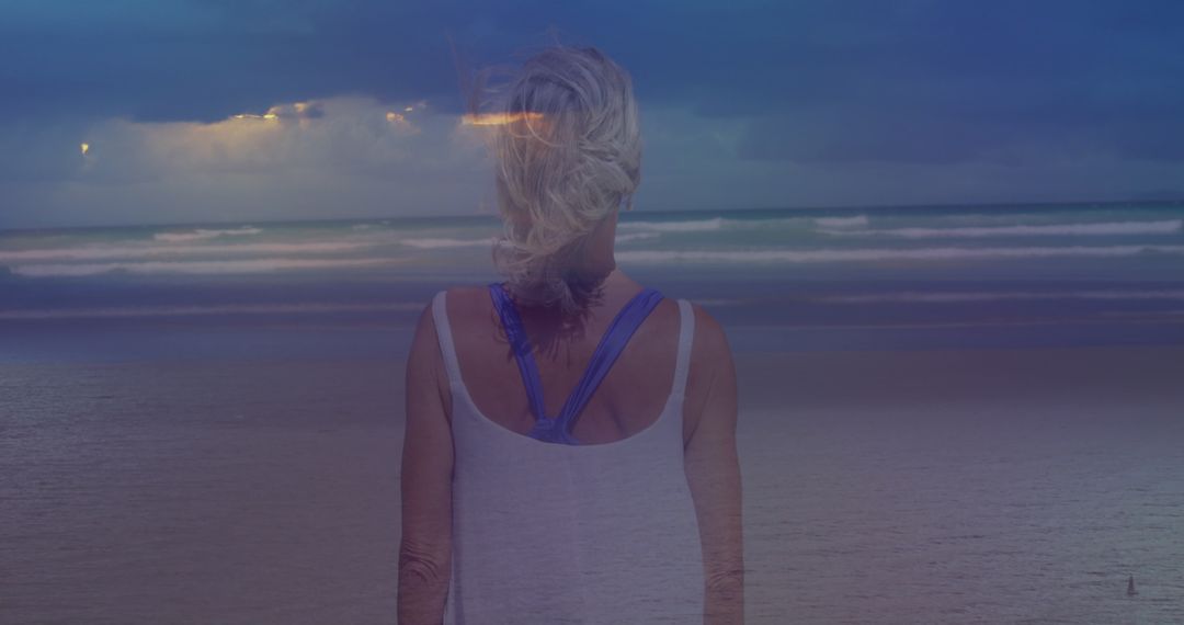 Contemplative Woman by Ocean during Dusk