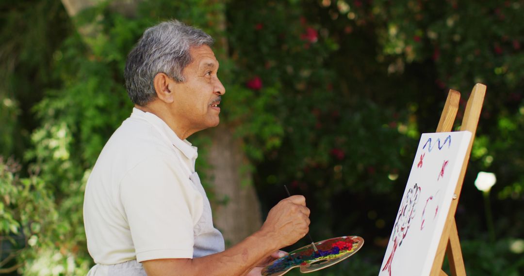 Image of focused biracial senior man painting in nature - Free Images, Stock Photos and Pictures on Pikwizard.com