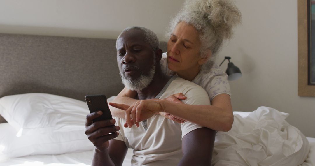 Senior Couple Relaxing in Bed Using Smartphone - Free Images, Stock Photos and Pictures on Pikwizard.com