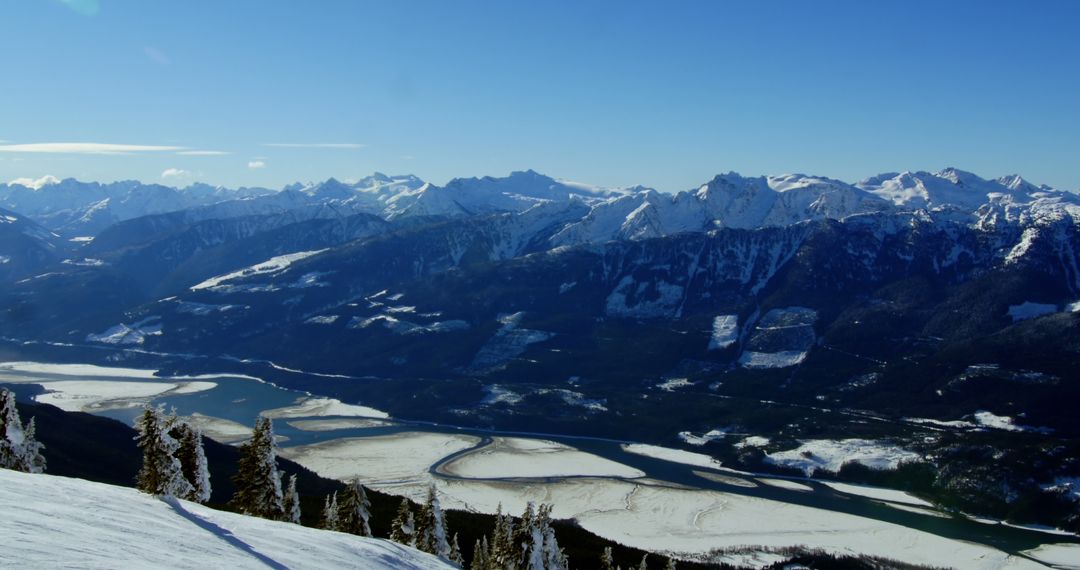 A serene snow-capped mountain panorama with a frozen river, perfect for winter activities. - Free Images, Stock Photos and Pictures on Pikwizard.com