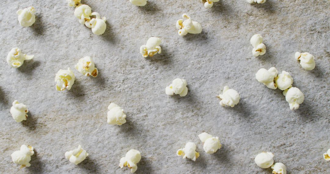 Scattered Popcorn Close-Up Against Gray Background